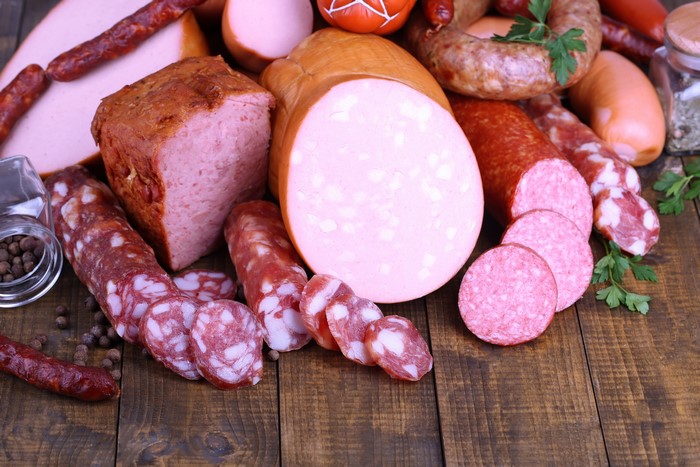 Assortment of sausages and meat products on wooden planks