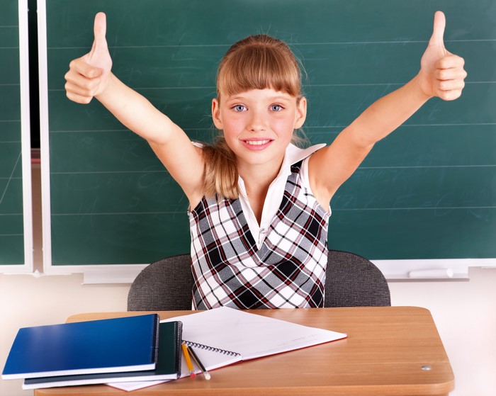 4K Image of Smiling Schoolgirl Giving Thumbs Up