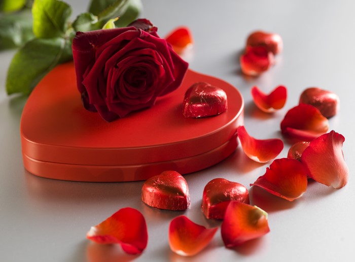 Red Rose on Heart-Shaped Box with Chocolates and Petals