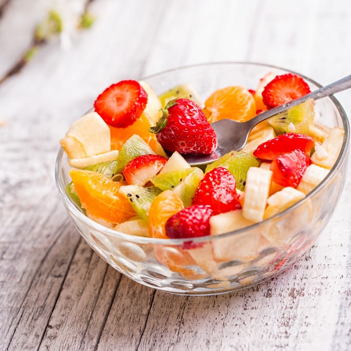 Fruit salad with strawberries, oranges, kiwi, and bananas