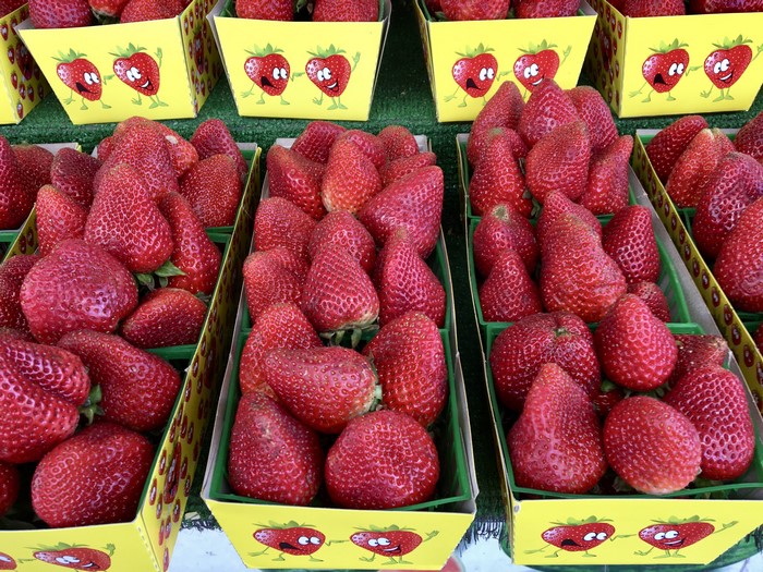 Strawberries in yellow containers