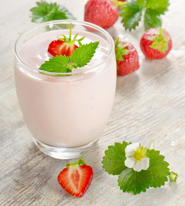 Strawberry yogurt in a glass with fresh strawberries