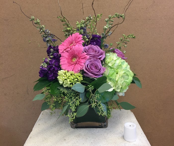 Floral arrangement with gerberas, roses, and hydrangea