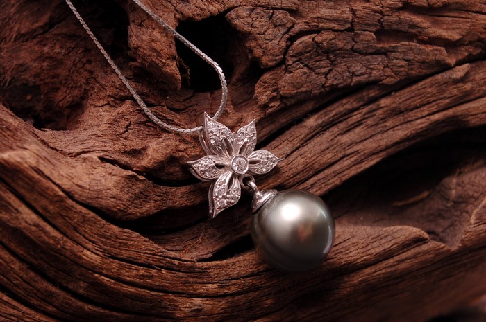 4K Closeup of a Flower Pendant Necklace with Pearl