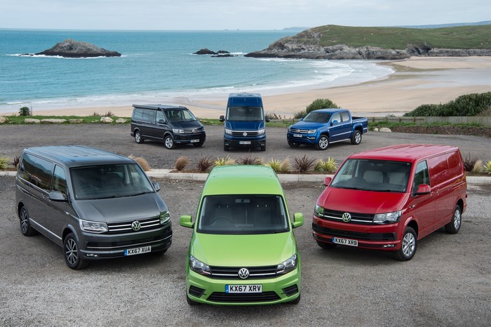 Volkswagen vans and pickup truck on a beach