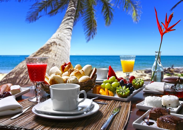 Beach breakfast with fruit and pastries