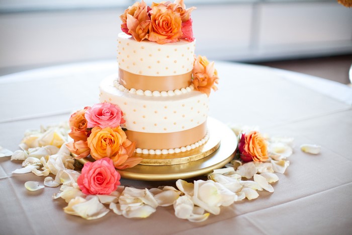 Two-tier cake with roses and petals