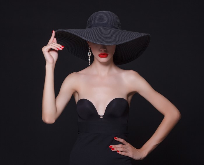 Woman in black hat and dress with red lipstick