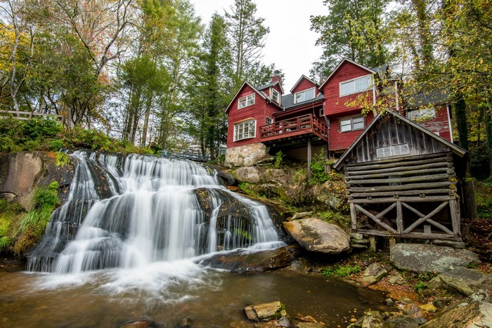 Waterfall near red houses in Transylvania, North Carolina, USA