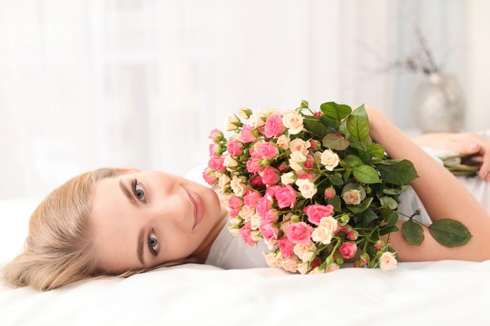 Blonde girl with bouquet of roses