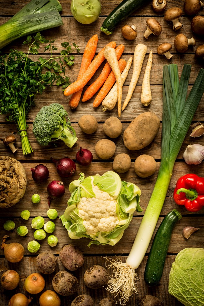 Assortment of fresh vegetables on wooden planks