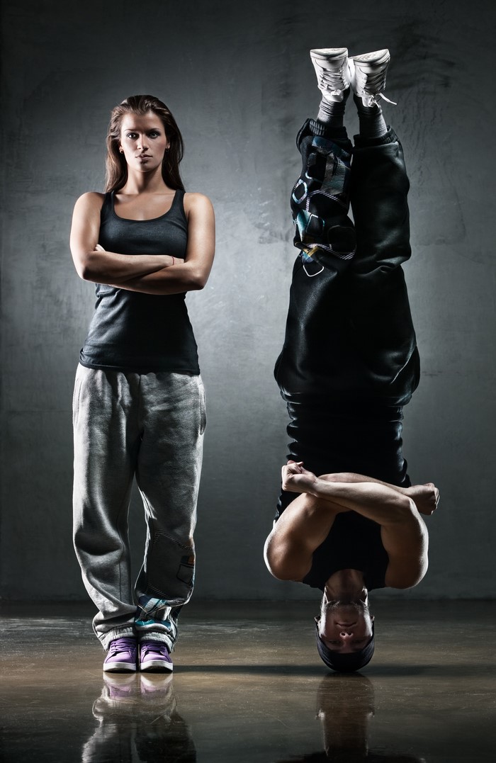 Woman and man breakdancing