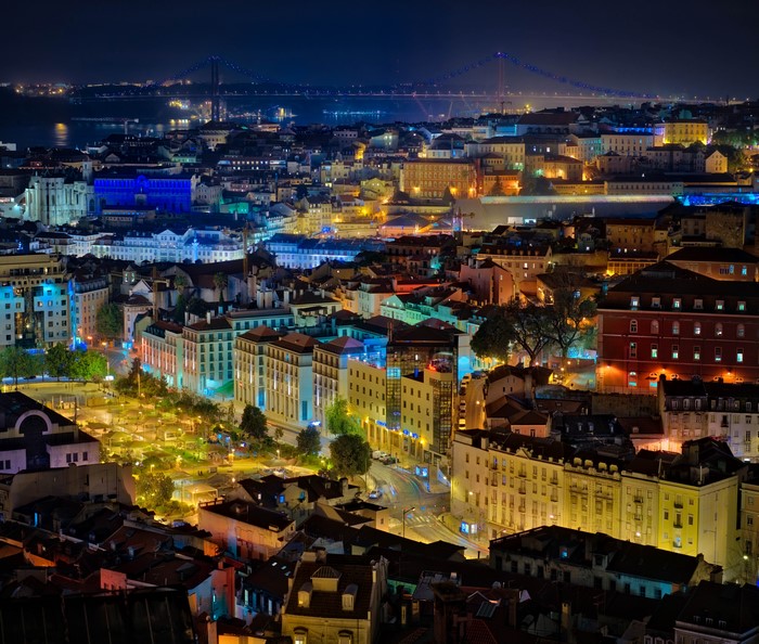 Lisbon cityscape at night with bridge