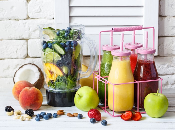 Fruit and Smoothies in Blender and Bottles