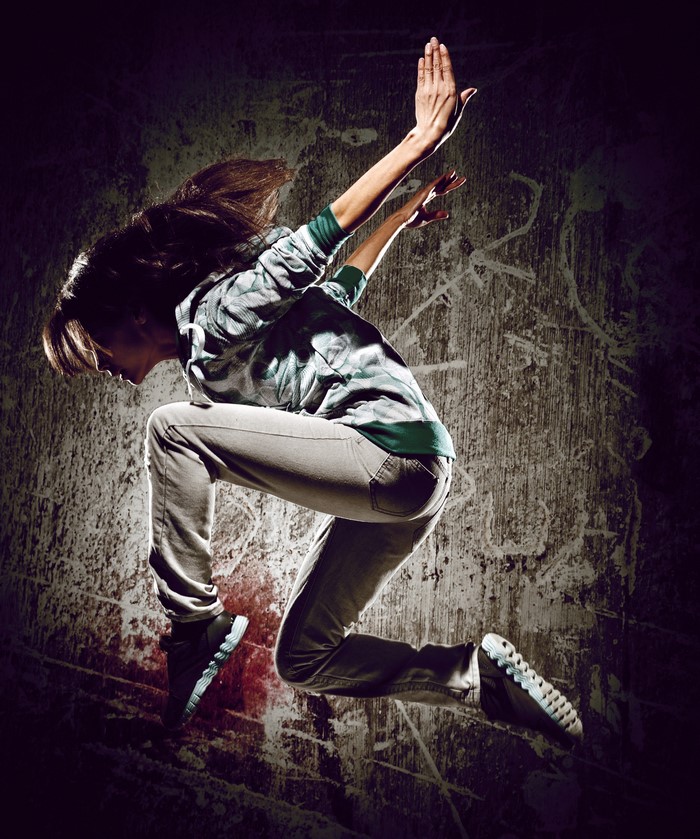 Woman in mid-air jump, dancing