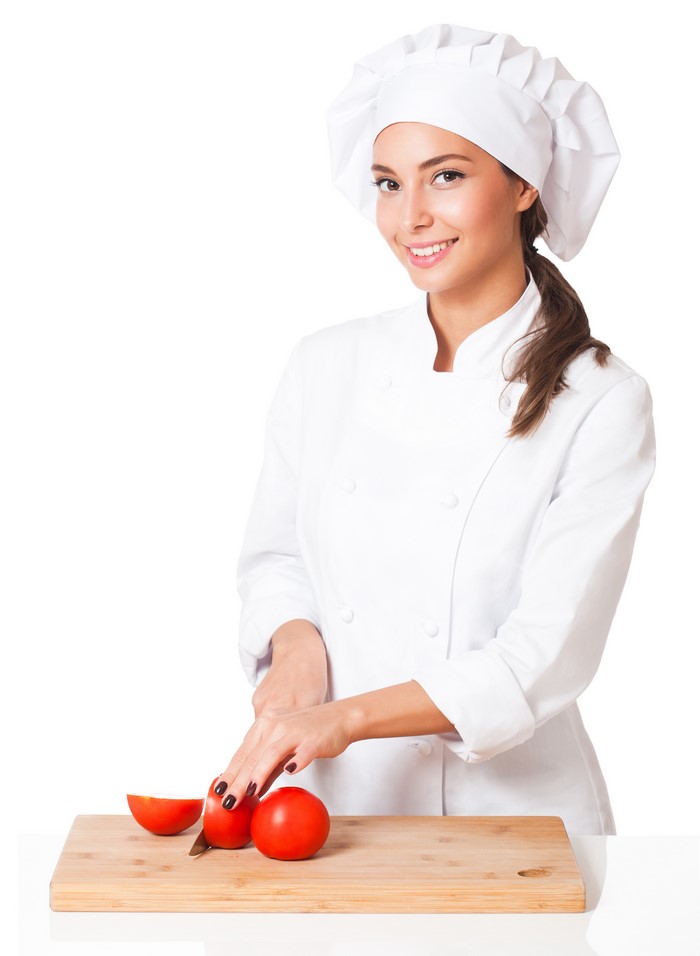 Chef cutting tomatoes on a wooden board
