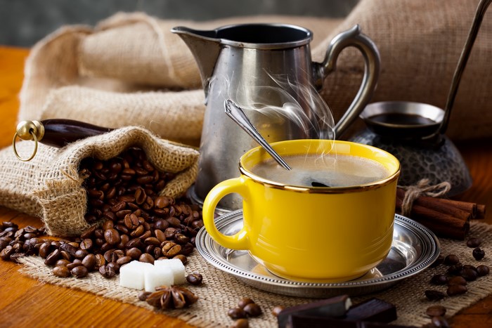 Coffee beans, cup, and coffee pot