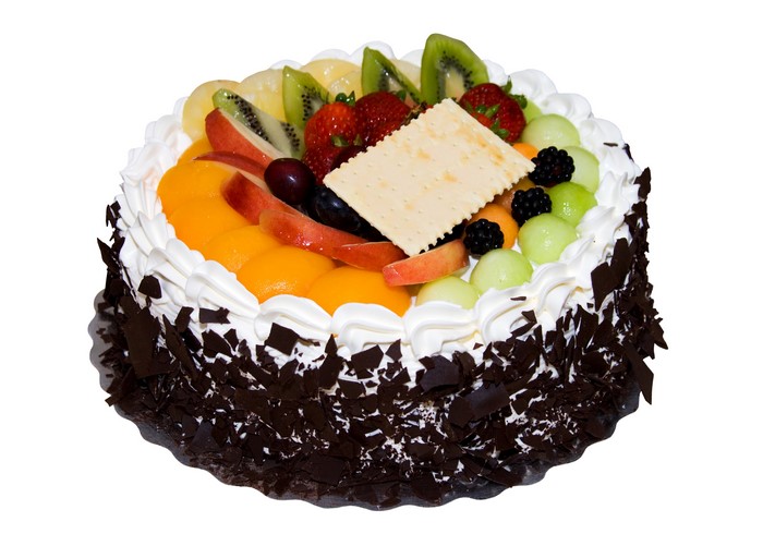 Fruit cake with chocolate shavings and white frosting