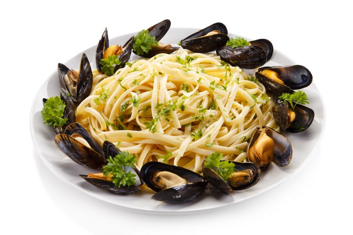 Pasta with mussels on a white plate