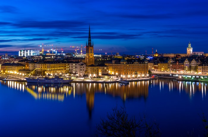 Stockholm cityscape at night with reflections in water