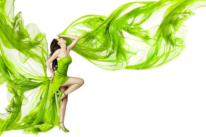Woman in green dress with flowing fabric
