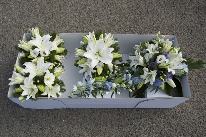 Three white lily bouquets in a box
