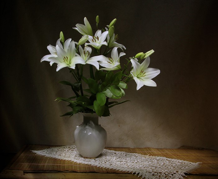 White lilies in a vase on a table