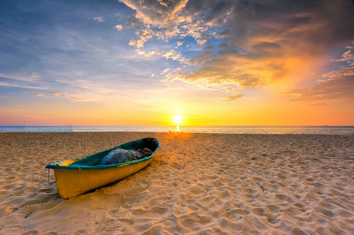 Boat on a beach at sunset