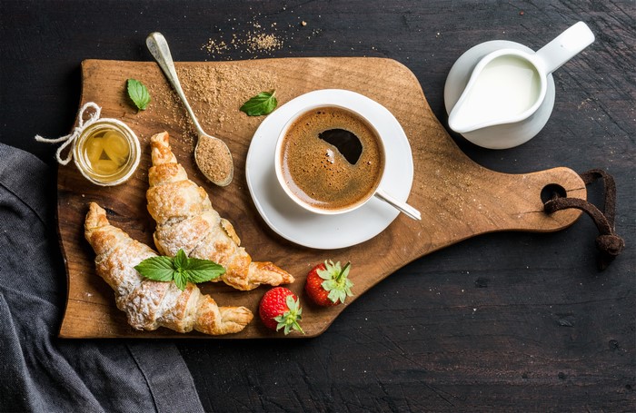 Coffee and Croissants on a Cutting Board
