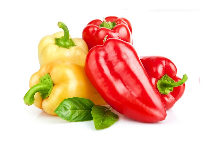 Red and yellow bell peppers with basil leaves