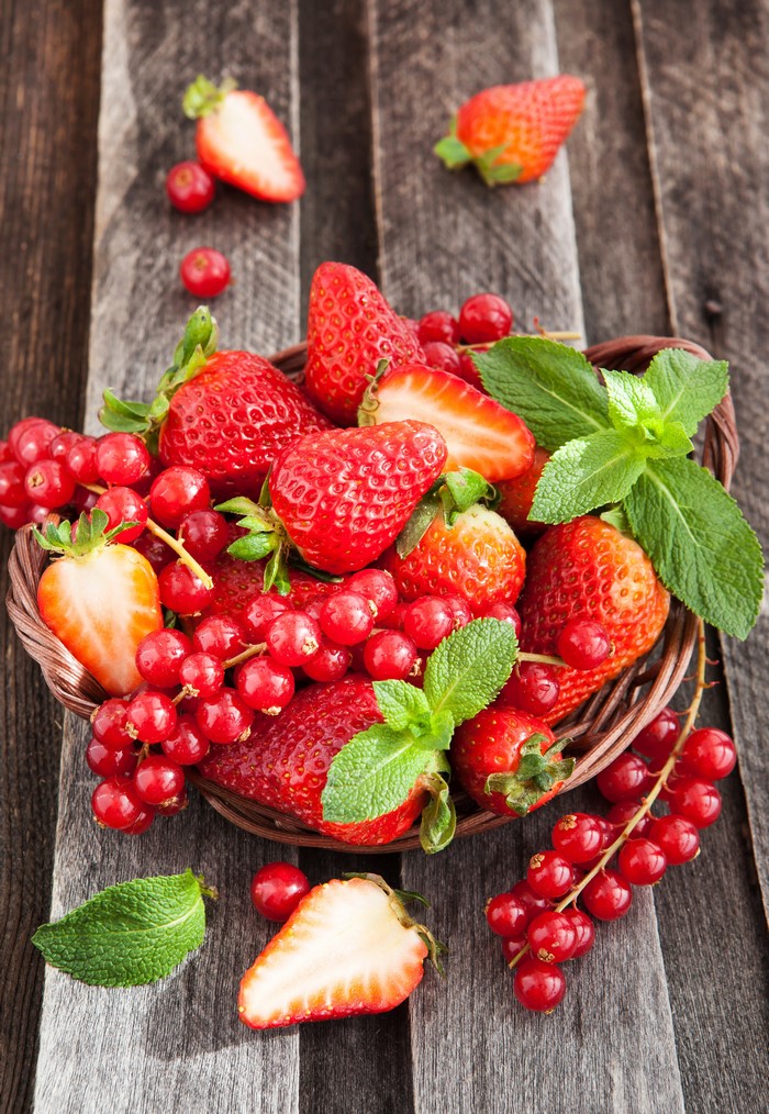 Basket of Strawberries and Currants on Wood