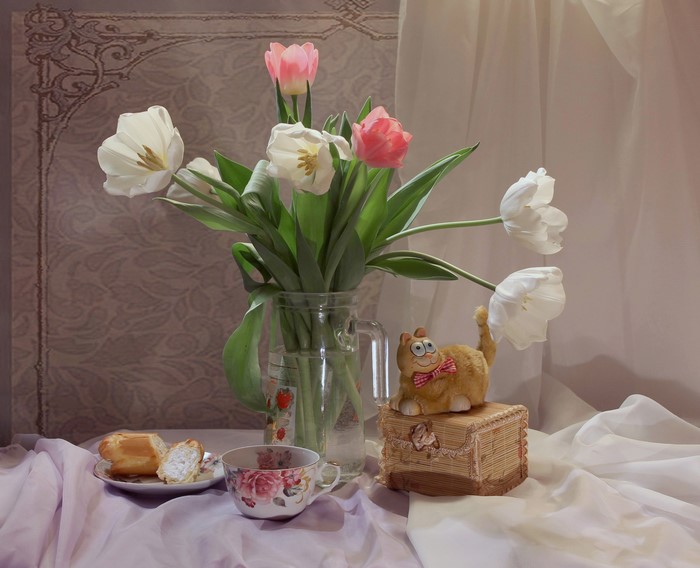Still-life with tulips, cup, and cat figurine