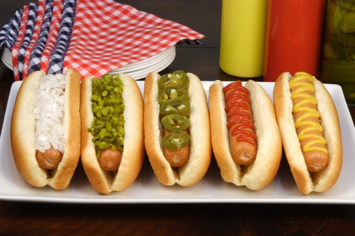 Hot dogs with various toppings on a plate