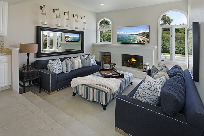 Living room with sofas, fireplace, and large mirror