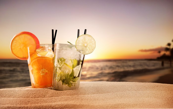 Two cocktails on a beach at sunset