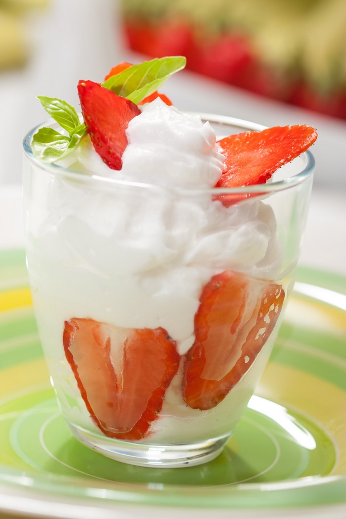 Strawberry dessert with whipped cream and mint