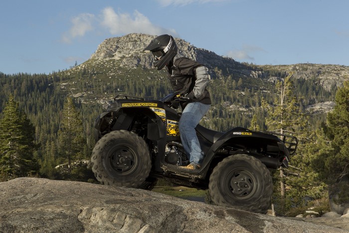 Man riding a Kawasaki Brute Force ATV on rocky terrain