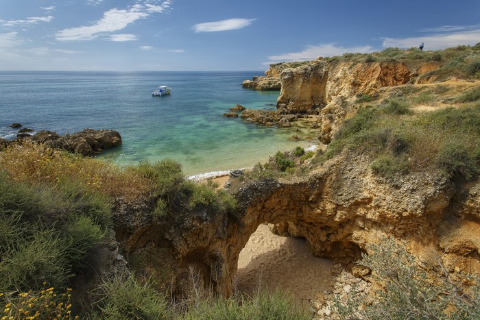 Praia dos Arrifes, Portugal Coastline with Boat and Arch