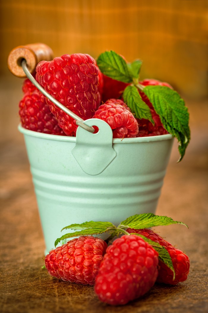 Raspberries in a small bucket