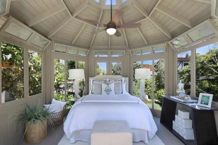 Bedroom with bed, lamps, and ceiling fan