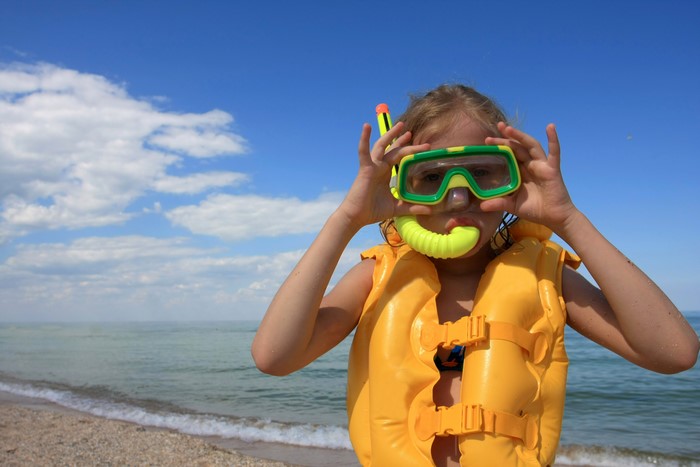 Girl in Snorkel Gear and Life Vest on Beach