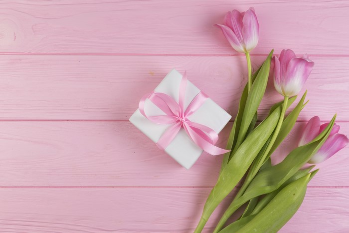 Pink Tulips and Gift Box on Pink Wooden Background