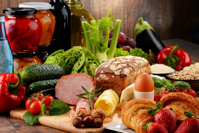 Assortment of Food: Bread, Ham, Eggs, Vegetables, and Fruits