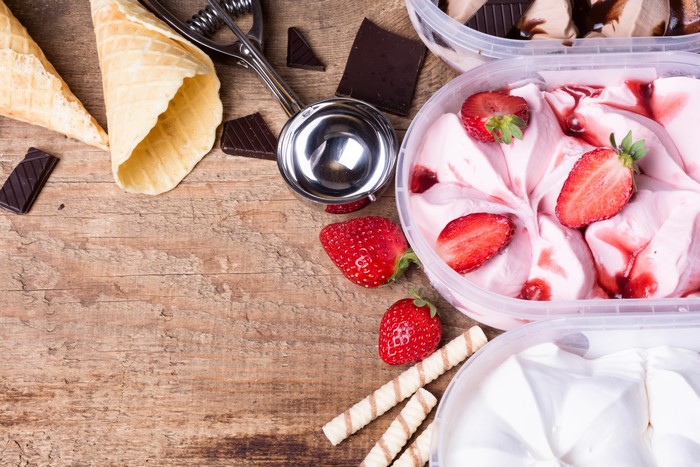 Ice cream cones, chocolate, strawberries, and ice cream tubs
