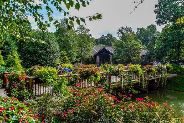 Gibbs Gardens bridge with flowers and pond
