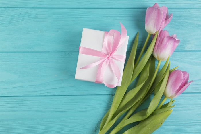 Pink Tulips and Gift Box on Blue Wooden Background