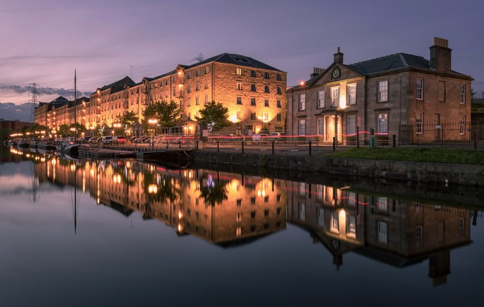 Buildings and river reflection at night in Glasgow, Scotland