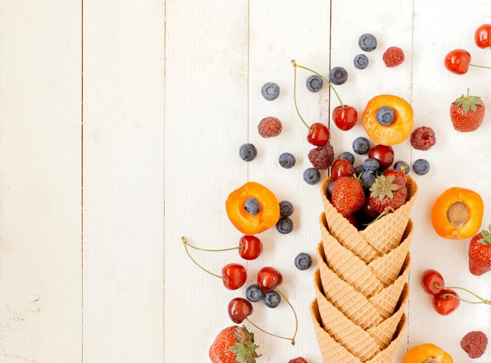Berries and Apricots in Waffle Cones on Wood