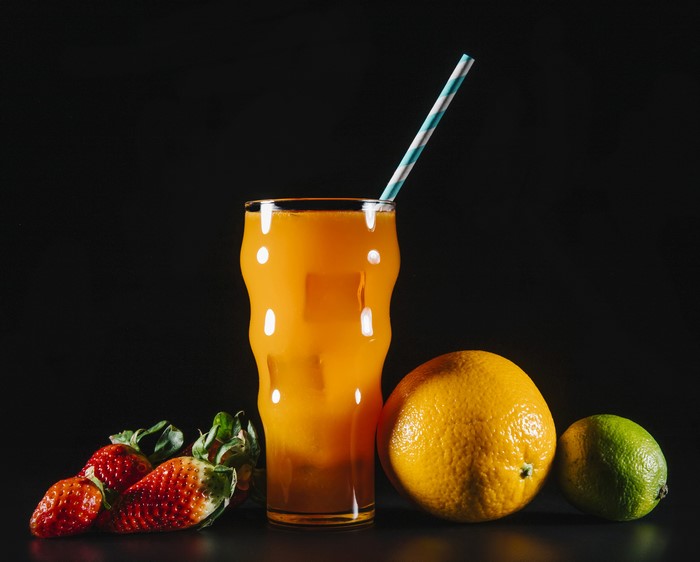 Orange juice with strawberries, orange, and lime