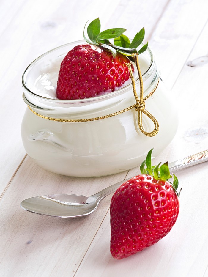 Strawberry and yogurt in a jar with a spoon